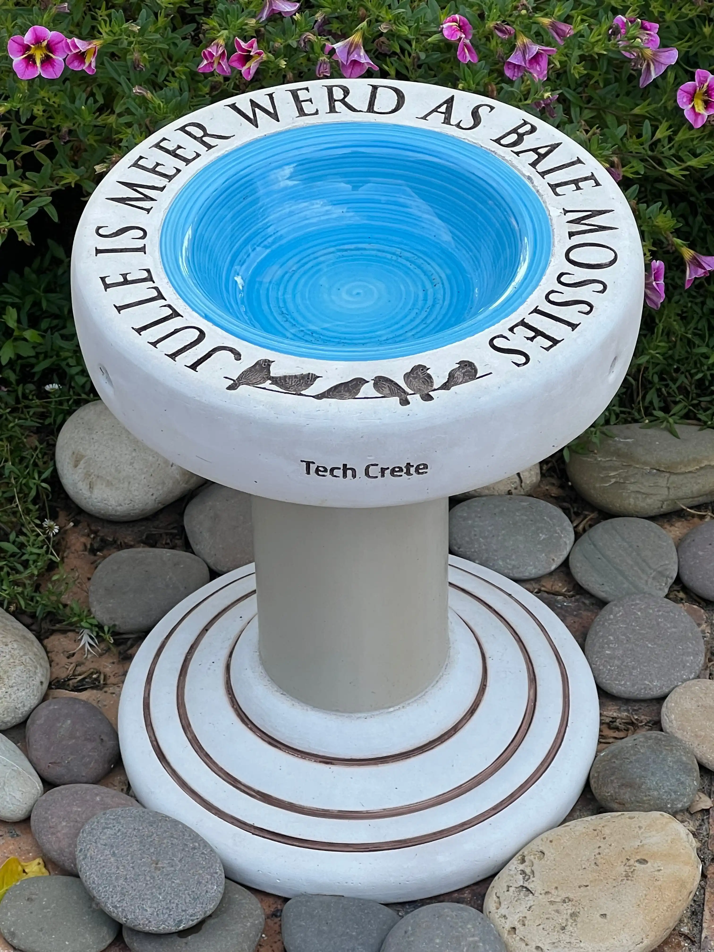 Close detail of hand-engraved concrete birdbath